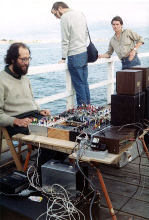 Warren Burt: Natural Rhythm 1983. Hydrophone, water gongs, Serge, Driscoll and home-brew modules, Gentle Electric Pitch to Voltage, Auratone Loudspeakers. St. Kilda Festival, St. Kilda Pier, Melbourne.